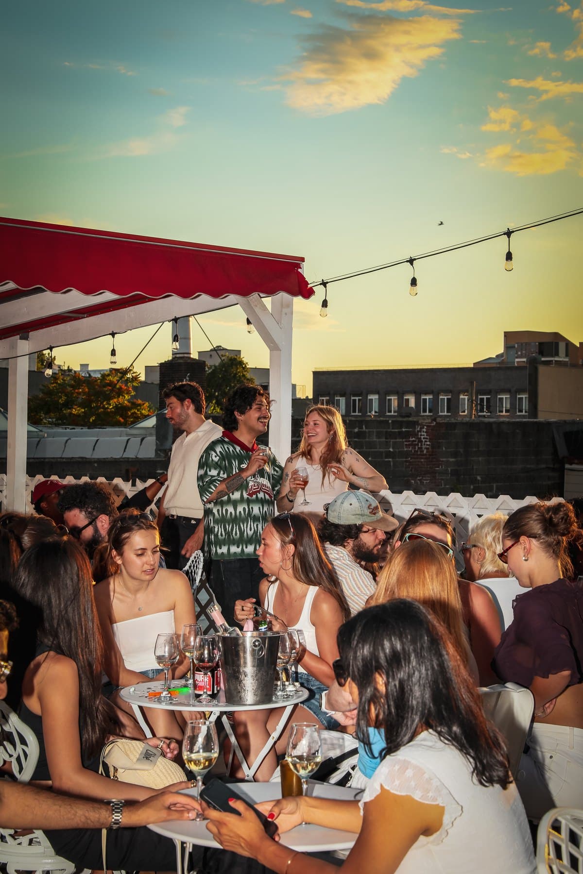 A full rooftop at golden hour during a Skirtts Sounds night